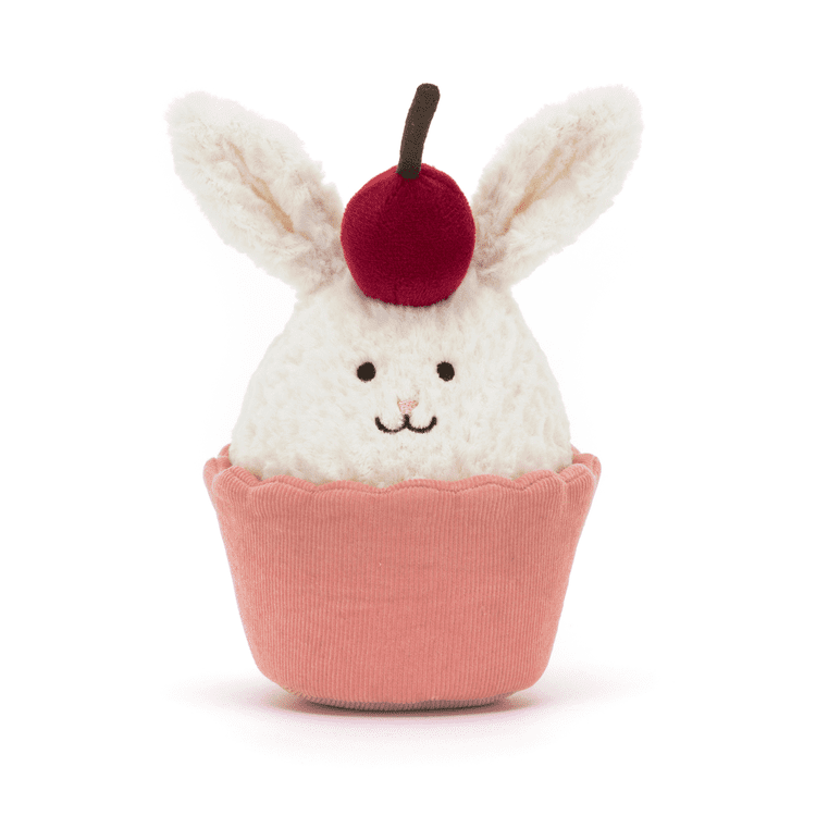 A bunny shaped cupcake in a pink liner, complete with a cherry between the ears