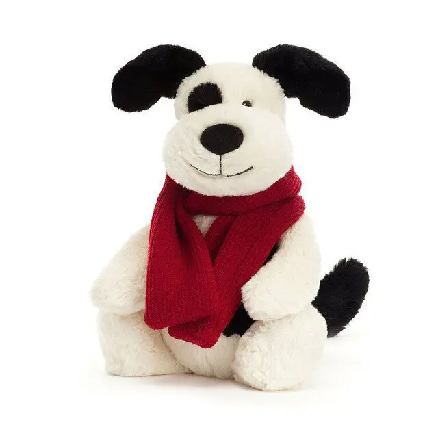 Black and white Bashful Puppy wearing a red scarf for winter